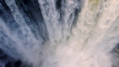 dramatic heavy white waterfall crashing into river below - eyipantla falls