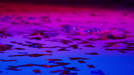 Close-Up-Of-Sparkling-Confetti-On-Floor-Of-Nightclub-Bar-Or-Disco-With-Flashing-Strobe-Lighting-2