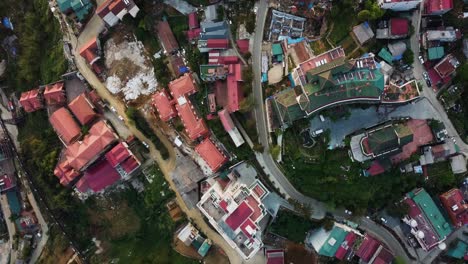 drone shot looking down on a typical low rise asian town featuring a vacant block of land