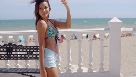 sexy young woman strolling along a promenade