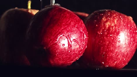 close up, water droplets splashing on red apples