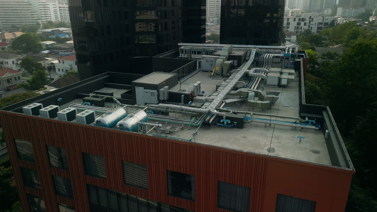 Building rooftop with HVAC and cityscape