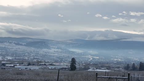 cloud formations above a snowy city in the mountains
