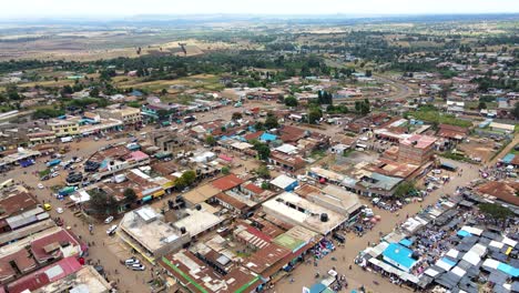 Aerial-view-of-cars-and-people-at-a-Open-Air-Market,-in-Africa---reverse,-drone-shot