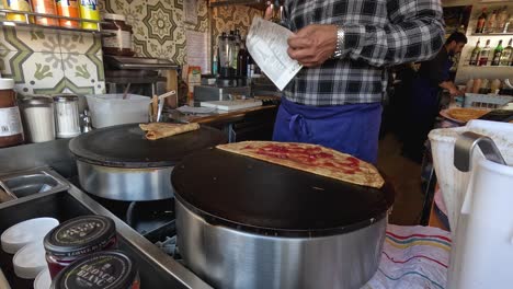 chef preparing crepes at a street food stall