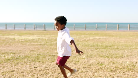 fun, boy and sea happiness of a child playing