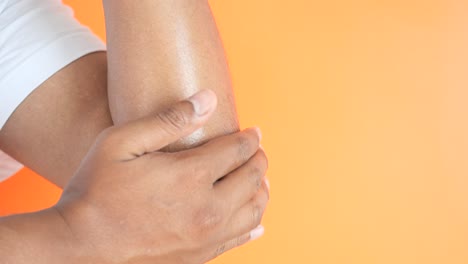 man applying lotion to his elbow