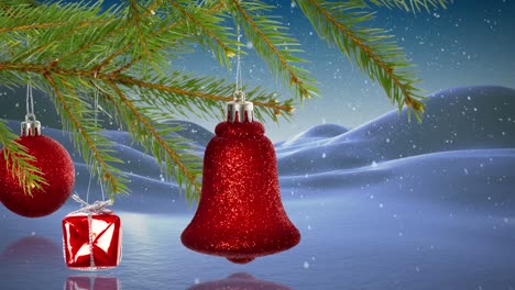 animation of branch with baubles and bell and snow falling over winter scenery