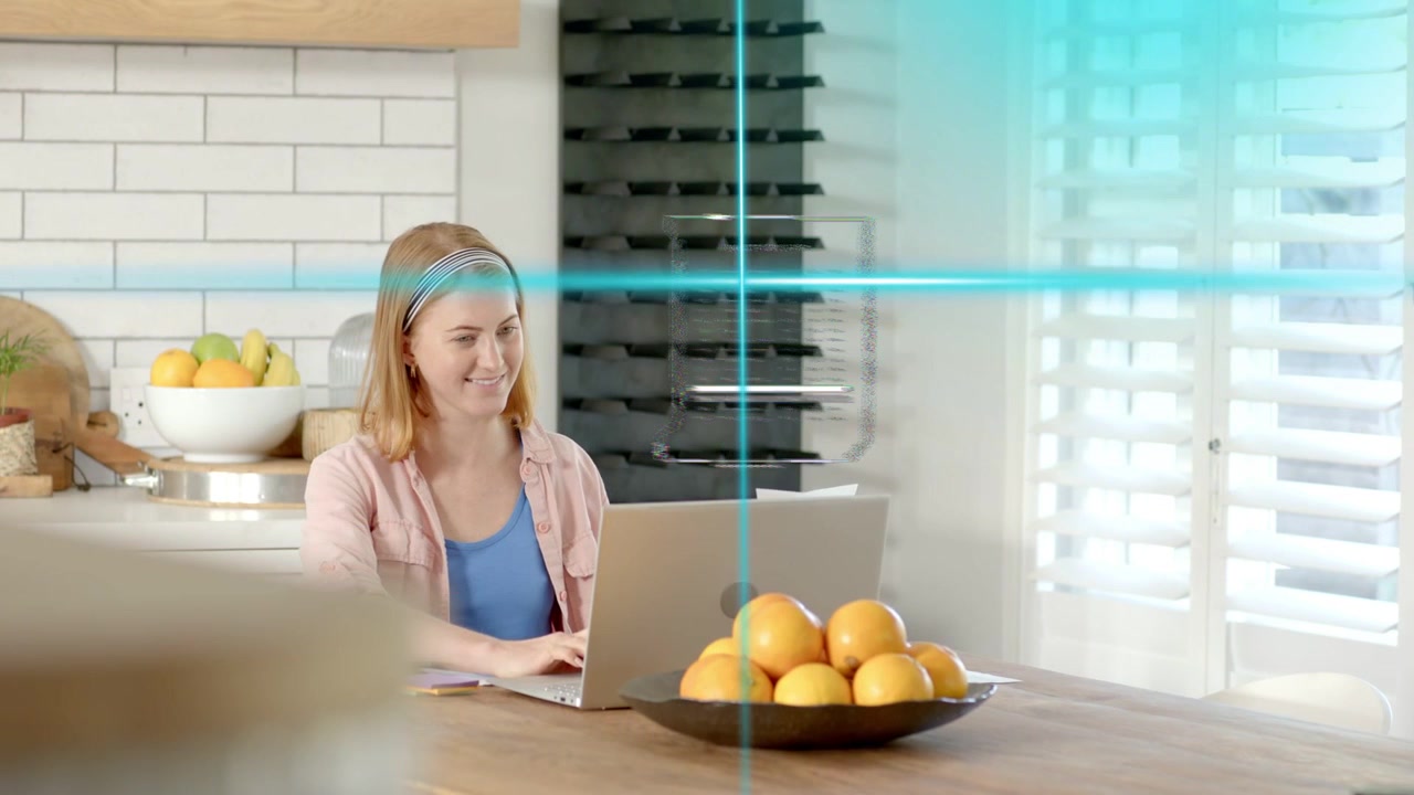 Woman starting typing on laptop, initiating blue HUD lines sweeping scene, managing finance papers