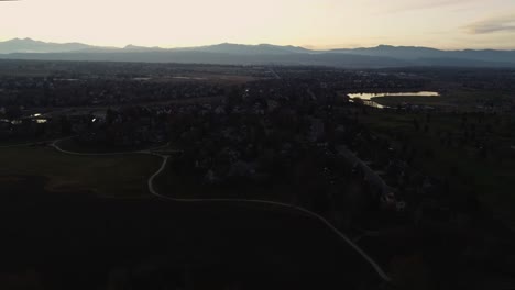 Rocky-mountain-sunset-from-a-drone-over-a-suburban-neighborhood,-4k-60fps