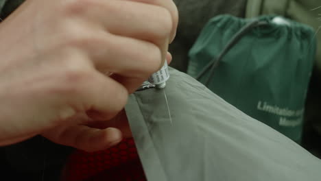 close-up of a woman reparing a hole in an camping mattress with the help of glue