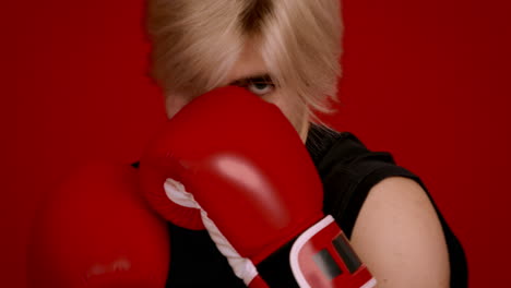 woman boxing, red gloves, red background