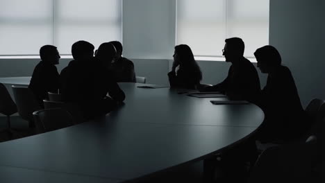 silhouetted business meeting in a conference room