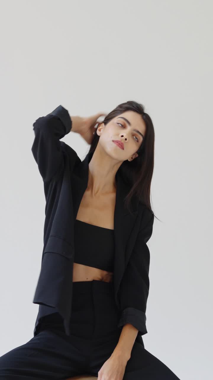 Fashion portrait of a woman wearing a black suit