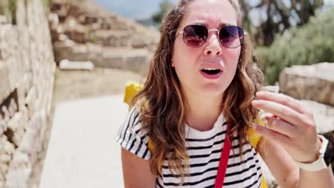 young tourist vlogging on a path at a historic site, athens, greece