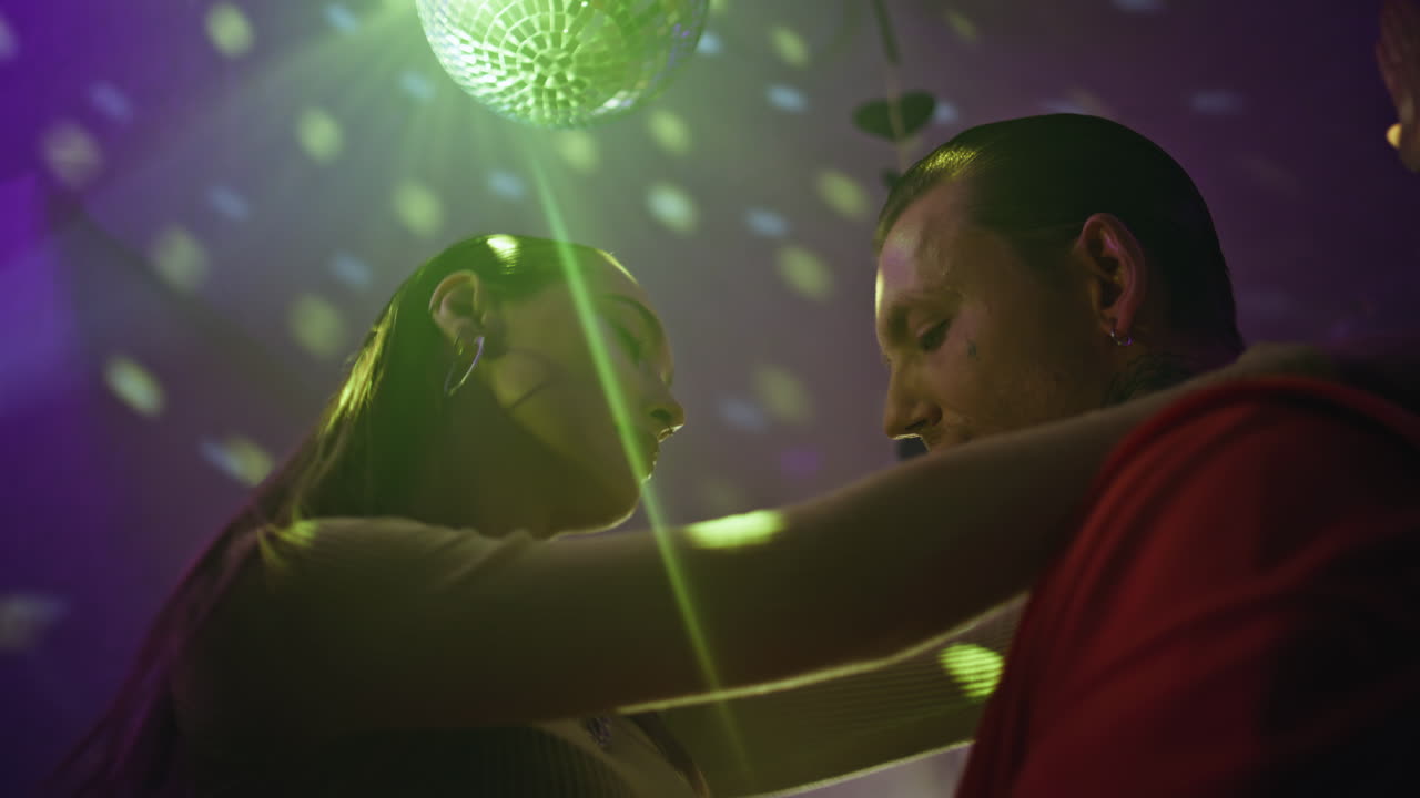 Loving couple dancing disco ball expressing passion closeup. Carefree clubbers