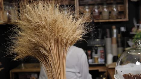 close-up of a bunch of wheat spikelets in a grocery bread store.