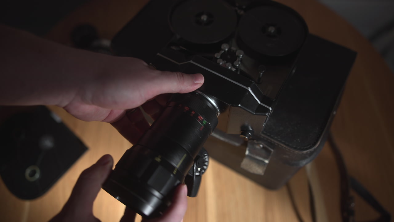Hands Attaching Lens To Vintage Camera Body, Precise Alignment And Mount, Rotating Motion To Secure Fit, . Media