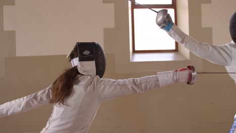 fencer athletes during a fencing training in a gym