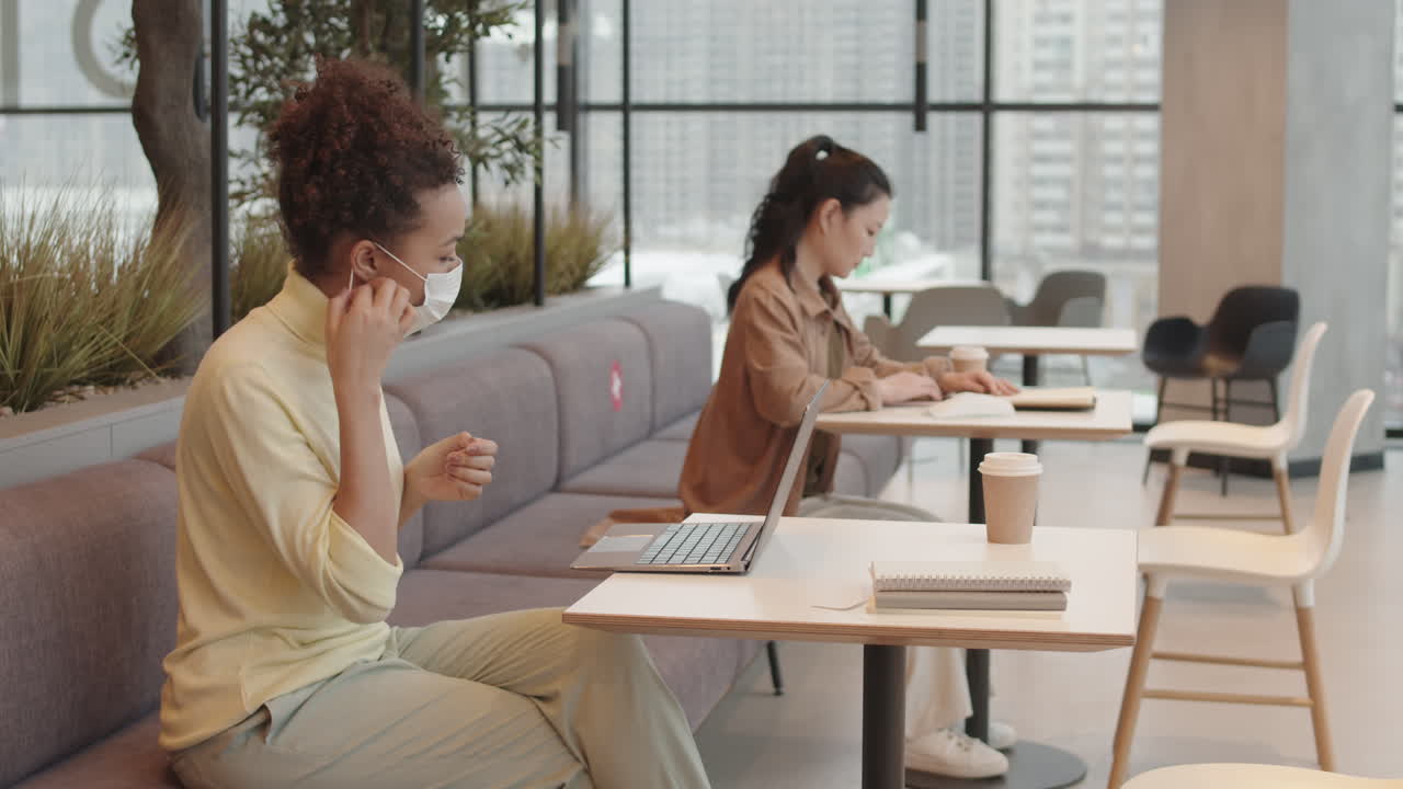 Woman Taking off Mask in Restaurant