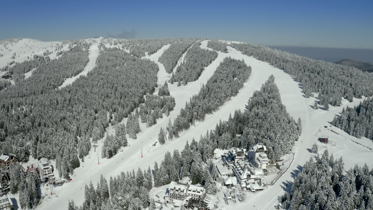 Aerial View of a Snow-Covered Mountain Ski Resort with Slopes