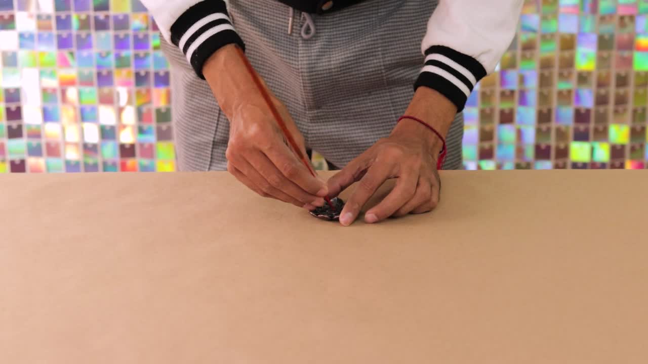 Person lighting incense stick in lotus incense holder