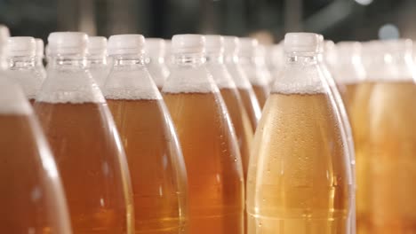 conveyor belt with bottles for juice or water at a modern beverage plant. modern production of sweet soda water