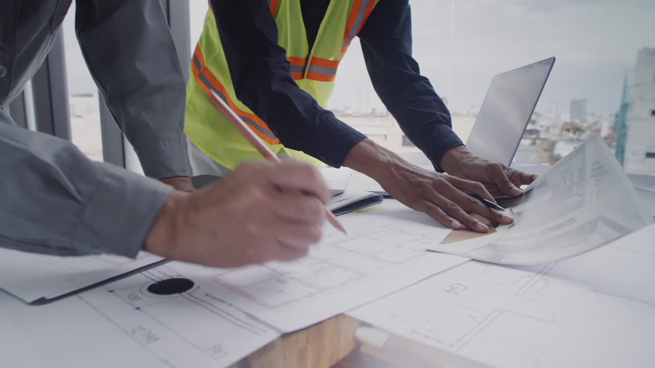 Engineers Working on Construction Plan