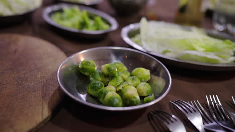 tender cooked brussels sprouts served with fresh ingredients for traditional bagna cauda.