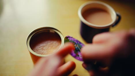 man get a teaspoon of honey and mix with hot coffee. - closeup shot