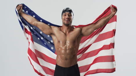 athletic biracial athlete swimmer celebrates victory wrapped in the american flag