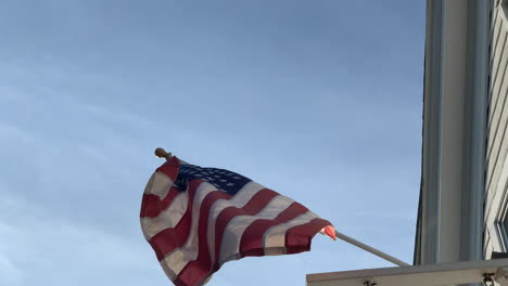 an american flag gently blows in the breeze on a summer day