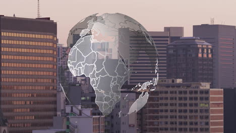 rotating globe animation over cityscape with tall buildings