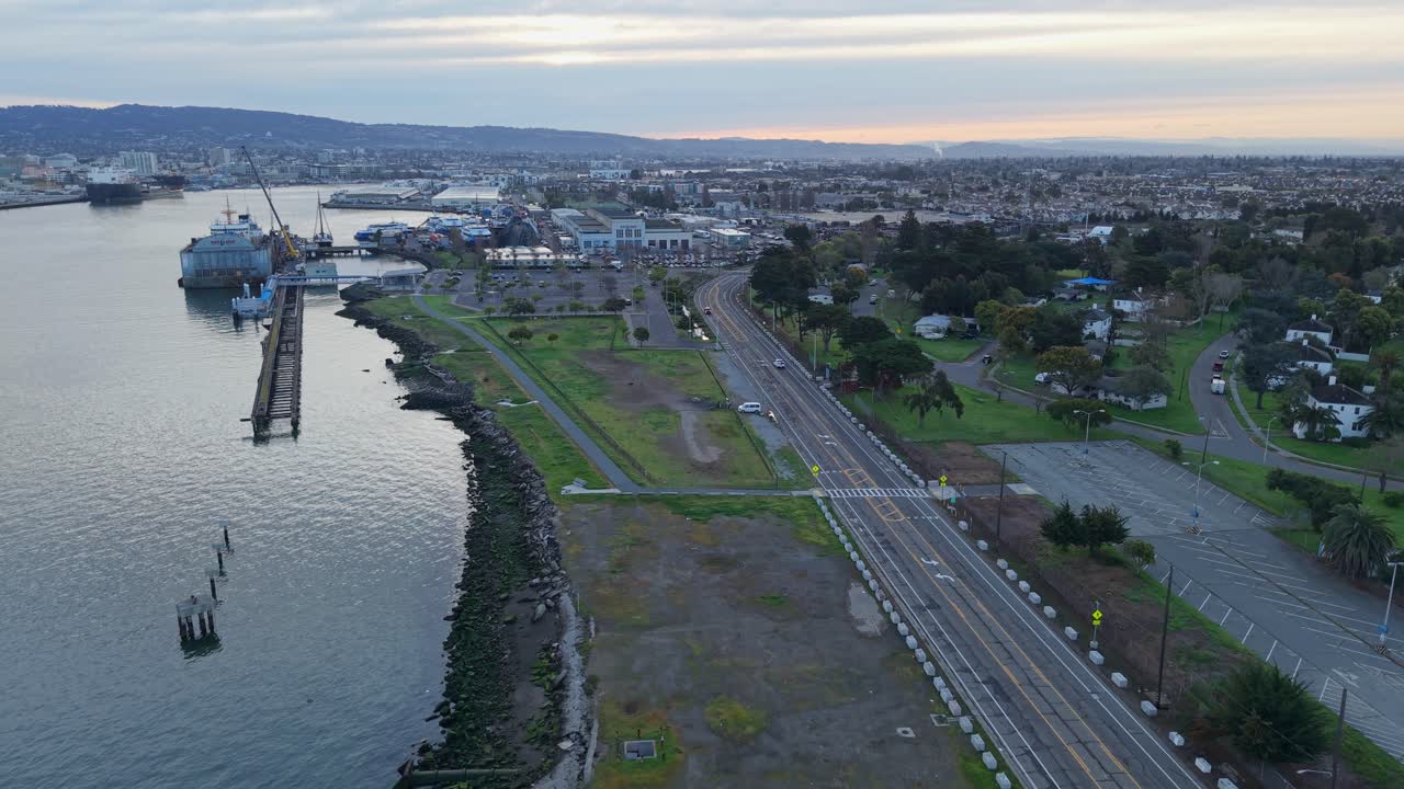 A slow ascending view of Alameda Point surrounded by urban developments. Shot on DJI Air 3S.