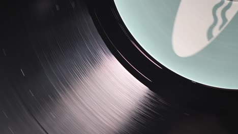 Close-up,-macro-shot-of-old-vinyl-disc-spinning-on-a-record-player