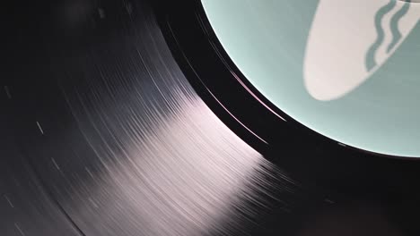 close up, macro shot of old vinyl disc spinning on a record player