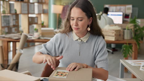 woman packing a cardboard box for shipping