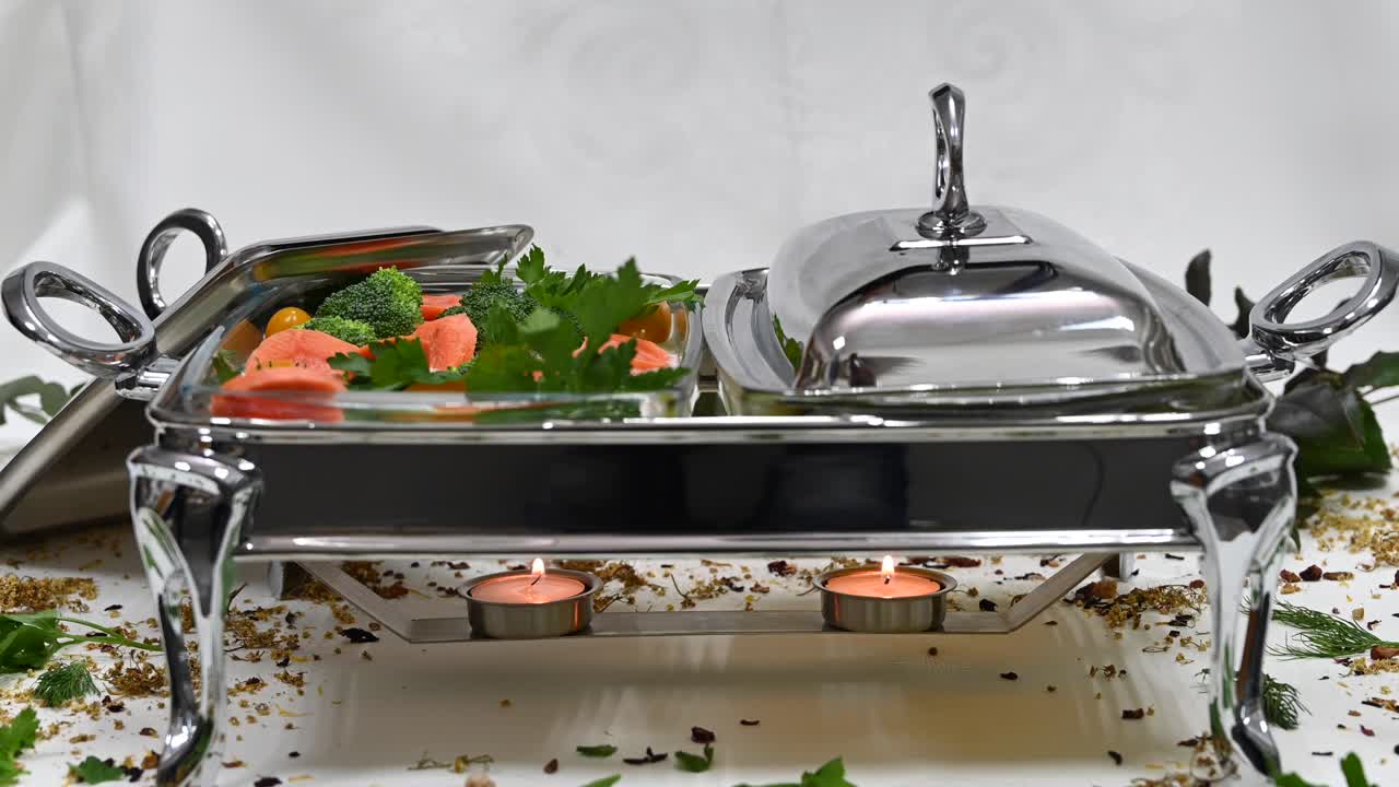 Close up of carrots and broccoli in sauce on a serving tray