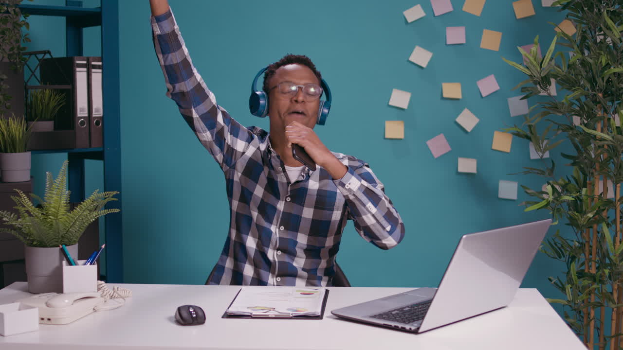 African american man recording and singing song on smartphone