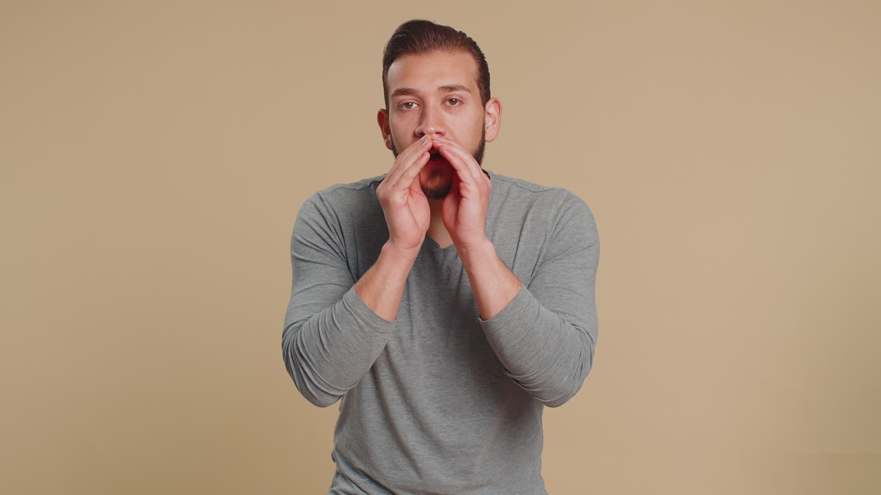 Young lebanese man whisper news rumors holding hands near mouth share gossip quiet keep my secrets