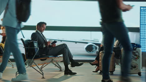 people waiting in the airport terminal
