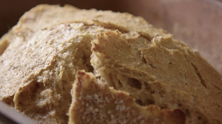 BAKING - Sourdough bread fresh from the oven, slow motion close up pan left