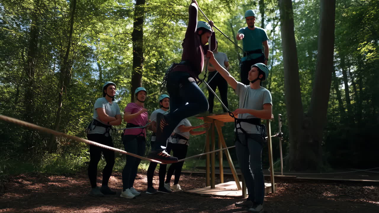 Group participating in a high ropes course adventure in the forest