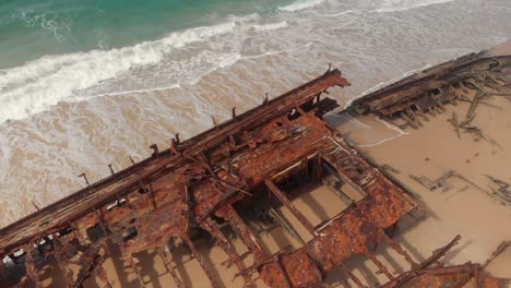 beautiful reveal of rusty wreck and magnificent beach on fraser island