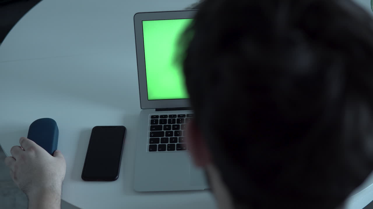 Man ending work at home office, fades the screen and gets up from the table