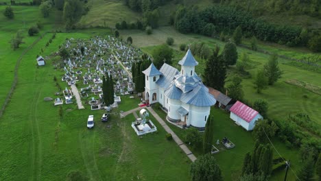 historic church and graveyard with greenery nature in palanca, bacau county, western moldavia, romania