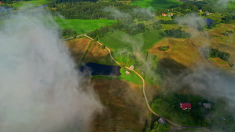 beautiful shot of clouds in the sky over a village in the green countryside