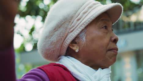 handheld view of mature woman pointing at something to tourists