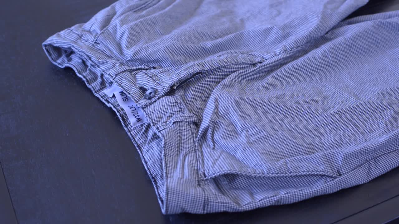 Footage of a person folding a pair of pants