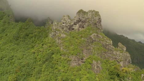 Aerial-shot-of-a-rock-formation-on-the-mountain-peak-in-Mo'orea-island,-a-high-island-in-French-Polynesia